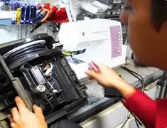 Vacuum repair technician servicing internal components on a workbench in Cedar Rapids, IA